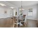 Elegant dining room with hardwood floors, stylish chandelier, and ample natural light at 6320 Halcyon Garden Dr, Alpharetta, GA 30005