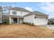 Charming two-story home with a covered patio, a garage, and manicured lawn and landscape at 6320 Halcyon Garden Dr, Alpharetta, GA 30005