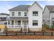 Charming two-story home boasts a welcoming front porch and well-maintained landscaping at 6320 Halcyon Garden Dr, Alpharetta, GA 30005