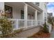 Inviting front porch with comfortable seating, perfect for relaxing and enjoying the outdoors at 6320 Halcyon Garden Dr, Alpharetta, GA 30005