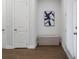 Hallway area with bench, doors, and dark hardwood flooring at 6320 Halcyon Garden Dr, Alpharetta, GA 30005