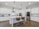 Bright kitchen features stainless steel appliances, white cabinets, pendant lights, and a large island at 6320 Halcyon Garden Dr, Alpharetta, GA 30005