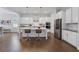 Gourmet kitchen with stainless steel appliances, white cabinets, an island and connection to dining area at 6320 Halcyon Garden Dr, Alpharetta, GA 30005