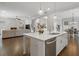 Bright open-concept kitchen featuring a large island, stainless steel appliances, and hardwood floors at 6320 Halcyon Garden Dr, Alpharetta, GA 30005