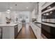 Modern kitchen with stainless steel appliances and large island, connects to the dining area at 6320 Halcyon Garden Dr, Alpharetta, GA 30005