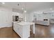 Open concept kitchen with a large center island and stainless appliances has views to the living room at 6320 Halcyon Garden Dr, Alpharetta, GA 30005