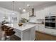 Bright, modern kitchen with stainless appliances, large island and views into dining area at 6320 Halcyon Garden Dr, Alpharetta, GA 30005
