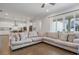 Bright living room with large windows that let in ample natural light and connect to the kitchen at 6320 Halcyon Garden Dr, Alpharetta, GA 30005