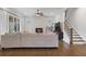 Spacious living room with a cozy fireplace, hardwood floors, and a staircase at 6320 Halcyon Garden Dr, Alpharetta, GA 30005