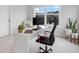 Well-lit home office with a view, featuring a modern desk and comfortable chair at 6320 Halcyon Garden Dr, Alpharetta, GA 30005