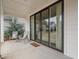 Inviting covered patio with outdoor seating overlooking the backyard and large sliding glass doors at 6320 Halcyon Garden Dr, Alpharetta, GA 30005
