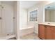 Bathroom boasts a bathtub, shower, and double vanity at 1013 Bluecoat Cir, Hampton, GA 30228