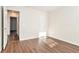 Bright bedroom with wood-look flooring and access to hallway at 1013 Bluecoat Cir, Hampton, GA 30228
