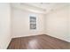 Simple bedroom with wood-look floors and a window at 1013 Bluecoat Cir, Hampton, GA 30228