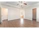 Spacious bedroom with wood-look floors and ceiling fan at 1013 Bluecoat Cir, Hampton, GA 30228