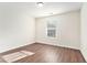 Sunny bedroom with wood-look floors and window at 1013 Bluecoat Cir, Hampton, GA 30228