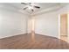 Bright bedroom featuring wood-look floors and ceiling fan at 1013 Bluecoat Cir, Hampton, GA 30228
