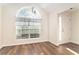 Dining area with an arched window and hardwood floors at 1013 Bluecoat Cir, Hampton, GA 30228