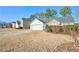 House exterior showcasing landscaping and driveway at 1013 Bluecoat Cir, Hampton, GA 30228