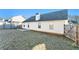Back of house with patio, yard, and wooden fence at 1013 Bluecoat Cir, Hampton, GA 30228
