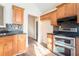 Kitchen with wood cabinets, tile backsplash and stainless steel appliances at 1013 Bluecoat Cir, Hampton, GA 30228