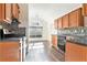 Kitchen with wood cabinets, tile backsplash and stainless steel appliances at 1013 Bluecoat Cir, Hampton, GA 30228