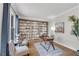 Bright home office with custom built-in bookshelves, a writing desk, and large picture windows at 302 N Brooke Dr, Canton, GA 30115