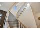 Modern staircase with black metal railing and light wood steps at 305 Gordon Ne Ave, Atlanta, GA 30307