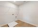 Laundry room with white walls and wooden floors at 5531 Rosehall Pl, Atlanta, GA 30349