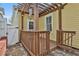 Wooden back deck area with a pergola and outdoor seating space surrounded by white fencing at 725 Oakland Se Ave, Atlanta, GA 30315