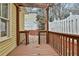 Wooden back deck area with a pergola and outdoor seating space surrounded by white fencing at 725 Oakland Se Ave, Atlanta, GA 30315