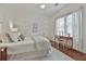 Light and airy bedroom featuring hardwood floors, a ceiling fan and a small desk area at 725 Oakland Se Ave, Atlanta, GA 30315