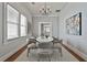 Elegant dining room with a white table, hardwood floors, six chairs, and a chandelier for cozy meals at 725 Oakland Se Ave, Atlanta, GA 30315