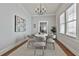 Cozy dining room with hardwood floors, modern chandelier, and seating for six, perfect for intimate gatherings at 725 Oakland Se Ave, Atlanta, GA 30315