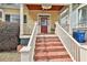 Inviting brick stairs lead to a cozy front porch with a charming porch swing at 725 Oakland Se Ave, Atlanta, GA 30315