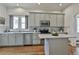Stylish kitchen with stainless steel appliances, custom cabinets, an island, and abundant counter space at 725 Oakland Se Ave, Atlanta, GA 30315