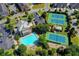 A vibrant aerial view of the neighborhood's pool, tennis courts, community center, and manicured greenery at 1284 Park Bench Pl, Mableton, GA 30126