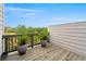 Outdoor deck with potted plants and distant view of tree tops at 1284 Park Bench Pl, Mableton, GA 30126