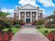 Attractive brick clubhouse featuring white columns, an impressive entrance, and beautifully landscaped surroundings at 1284 Park Bench Pl, Mableton, GA 30126