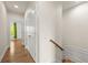 Hallway with hardwood floors, closet, and view of a bedroom with light from the window at 1284 Park Bench Pl, Mableton, GA 30126