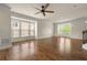 Bright living room featuring hardwood floors, a ceiling fan, and large windows at 1284 Park Bench Pl, Mableton, GA 30126