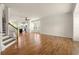 Living room with hardwood floors leading to a kitchen with stainless steel appliances at 1284 Park Bench Pl, Mableton, GA 30126