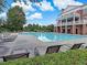 Resort style pool area with lounge chairs and a large brick clubhouse at 1284 Park Bench Pl, Mableton, GA 30126