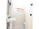 Small powder room featuring a corner sink and stained glass window, with a shower in the corner at 1830 W Taylor Ave, Atlanta, GA 30344