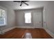 Spacious bedroom with natural light, hardwood flooring, ceiling fan and two doors at 1830 W Taylor Ave, Atlanta, GA 30344
