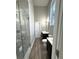 A well-lit bathroom with gray walls, double vanity, and a glass enclosed shower at 4863 Amsler Rd, Ellenwood, GA 30294