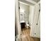 A small half bath features a dark-stained vanity with a mirror and wood-look flooring at 4863 Amsler Rd, Ellenwood, GA 30294