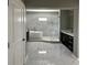 Bathroom features a soaker tub, glass enclosed shower and dark vanity with marble floors at 4863 Amsler Rd, Ellenwood, GA 30294