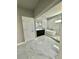 Bathroom features a soaker tub, glass enclosed shower and dark vanity with marble floors at 4863 Amsler Rd, Ellenwood, GA 30294