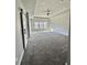 Bright bedroom with three windows, tray ceiling and a sliding barn door at 4863 Amsler Rd, Ellenwood, GA 30294